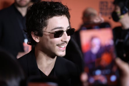man wearing black shirt and sunglasses smiles