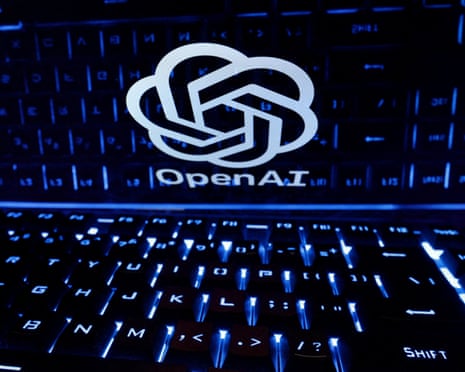 The OpenAI logo of interlocking shapes on a screen overlooking illuminated blue keyboard.