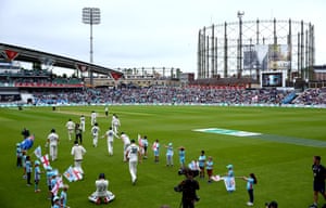 The Australian players and England’s batsmen Rory Burns and Joe Denly of England take to the field.