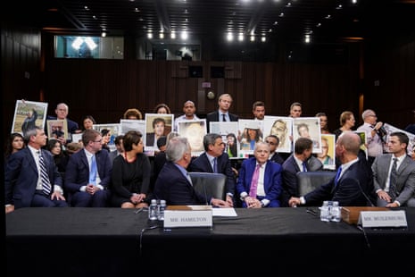 Family members of those who died in the twin 737 Max crashes hold pictures of the victims as a congressional hearing in Washintgon in October 2019.