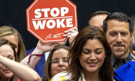 People gather as Florida’s governor, Ron DeSantis, signs the ‘stop woke’ bill in April 2022.
