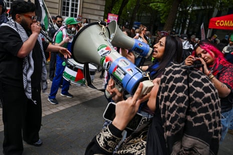 People use megaphones as demonstrators from the Palestine Solidarity Campaign hold a march.