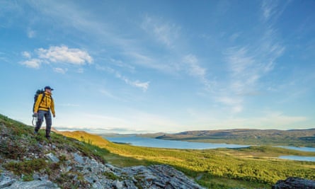 A summer landscape and traveler hiking in Finnish Lapland