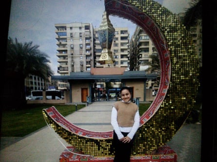 Girls sits on glittery outdoor sculpture shaped like the crescent moon