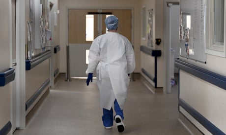 A member of staff walks in the ICU ward corridor at a Hospital