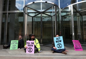 Protesters glue their hands to ground outside the LSE building.