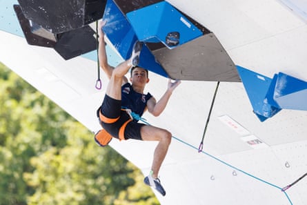 Toby Roberts holds on while attemping to get his footing on a difficult climbing wall