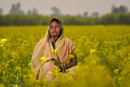 Asa Devi Sah Teli, in a field of flowers in Nepal.