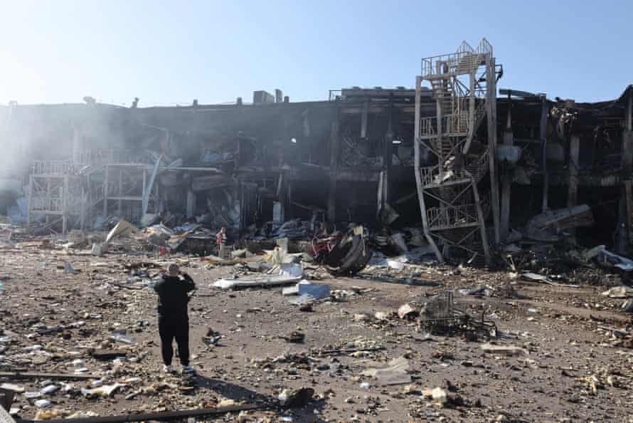 A man takes pictures of the destroyed shopping and entertainment centre in Odesa.