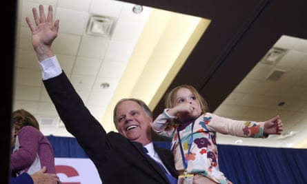 Doug Jones waves to supporters after the results were announced.
