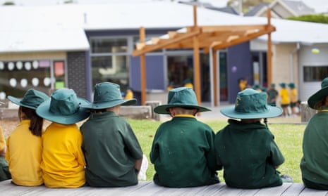 School children sitting in outdoor area.