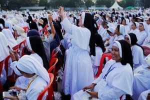 Nuns attend a mass led by the pontiff at Kyite Ka San football stadium in Yangon