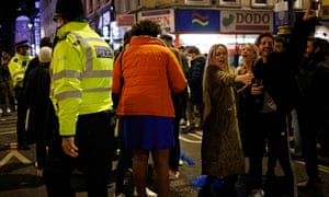 Police officers walk among the crowds as people drink in the street in the Soho area of London, on April 12, 2021 as coronavirus restrictions are eased across the country in step two of the government’s roadmap out of England’s third national lockdown.
