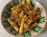 Rachel Roddy’s pasta with Senegalese-inspired ragu looks like A bowl of large tube pasta mixed with shredded meat in a spiced ragu.