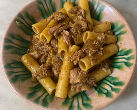 Rachel Roddy’s pasta with Senegalese-inspired ragu looks like A bowl of large tube pasta mixed with shredded meat in a spiced ragu.