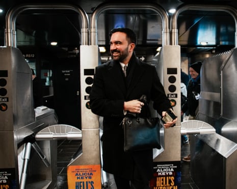 a man in a suit walks into an apartment smiling