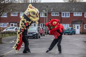 Matt Williams, a lion dance instructor from the World Eagle Claw Association UK, gives his costumes an airing with Greg Currie in Aldershot, UK