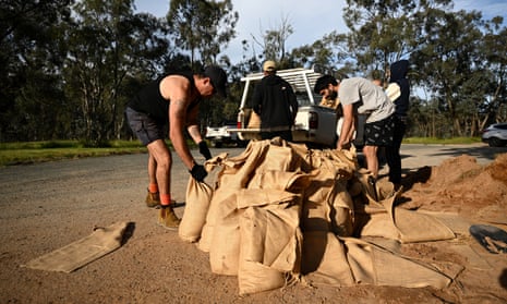 A group of young men prepare sandbags in Cumeroongunja, on the NSW border with Victoria.