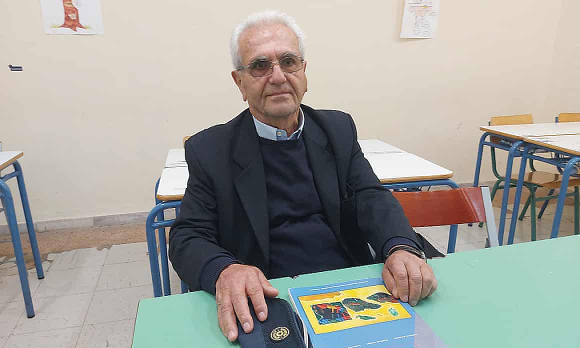 Octogenarian Vasillis Panayiotaropoulos sitting at a table.
