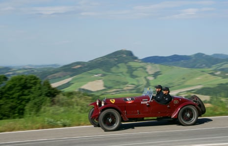 Vintage car speeding down a countryside road