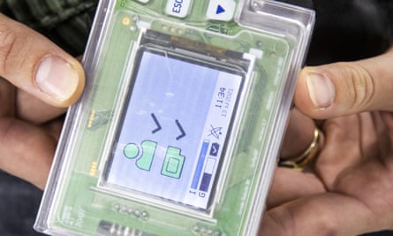 A pair of hands holding an artificial pancreas.