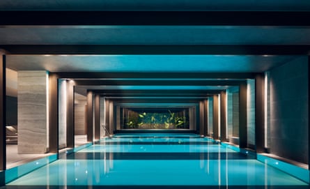 A swimming pool, reflected symmetrically above, with marble columns