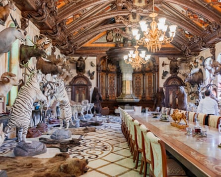 Stuffed tigers and other animals in an ornate dining hall