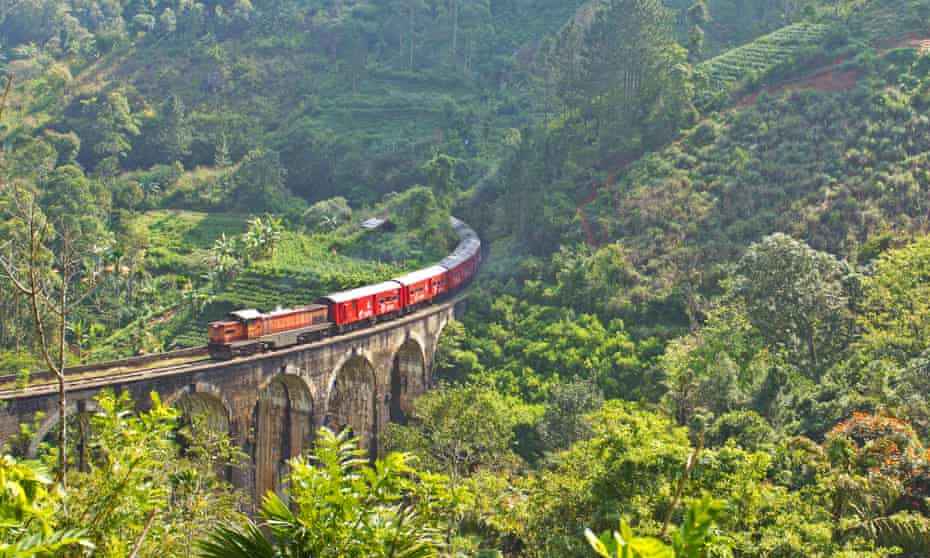 Passenger train crossing the nine arches viaduct near Ella, Sri Lanka. 