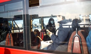 A person on a London bus is seen wearing a protective face mask, as the number of coronavirus cases worldwide continues to grow