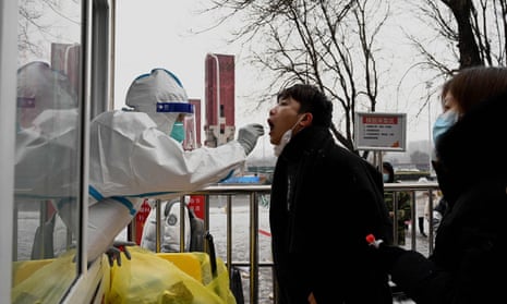 A health worker takes a swab sample from a man to test for the Covid-19 on a snowy day in Beijing.