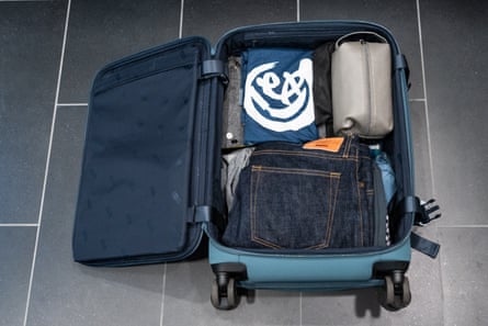 An open suitcase on tile floor