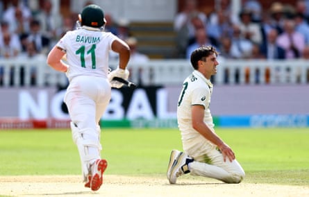 Pat Cummins is on his knees as Temba Bavuma takes a run