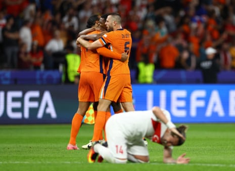 Netherlands’ Virgil van Dijk, Denzel Dumfries and Stefan de Vrij celebrate after the match as Turkey’s Abdulkerim Bardakci looks dejected.