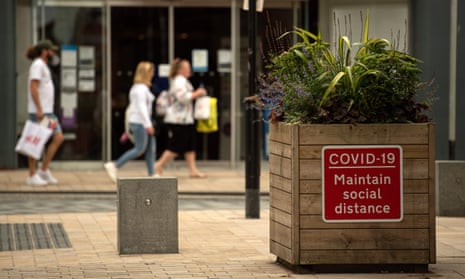 A notice advises members of the public to maintain a social distance in the city centre of Preston