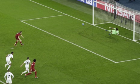Liverpool’s James Milner scores a penalty kick.