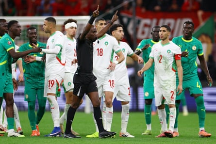 Referee Jean-Jacques Ngambo Ndala prepares to award Morocco’s late penalty after a VAR review in the Afcon final between Senegal and Morocco