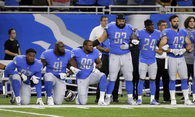 Members of the Detroit Lions kneel and stand during the national anthem last season