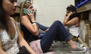 People take shelter inside the Sands Corporation plane hangar after the mass shooting in Las Vegas that killed more than 50.