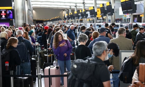 Passengers queue inside the departures terminal of Terminal 2 at Heathrow airport