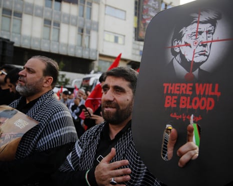 Mourners gather for Iran's former supreme leader, Ali Khamenei, carrying flags and a poster with Trump's face and the words 'there will be blood'.