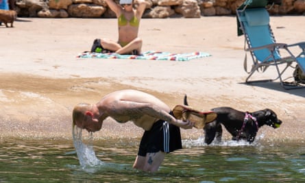 Dogs and residents enjoying the water at Barton Creek Pool in Austin, Texas June 27, 2023