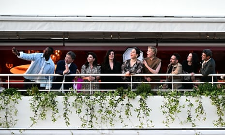 Omar Sy, Hirokazu Kore-eda, Ebru Ceylan, Nadine Labaki, Lily Gladstone, Greta Gerwig, Juan Antonio Bayona, Eva Green and Pierfrancesco Favino taking a photograph on a boat.