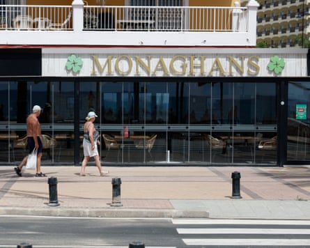 People walking into the front entrance of Monaghans Irish pub