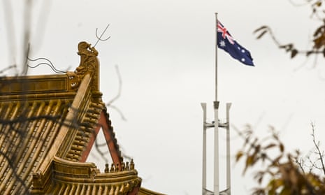 The flag pole of the Australian Parliament is seen behind the roofs of the Chinese Embassy in Canberra, Monday, June 29, 2020. 