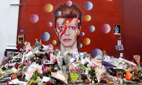Flowers and messages left by fans in front of the David Bowie mural in Brixton