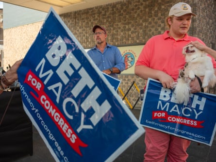 people hold signs that say âÂÂBeth Macy for CongressâÂÂ