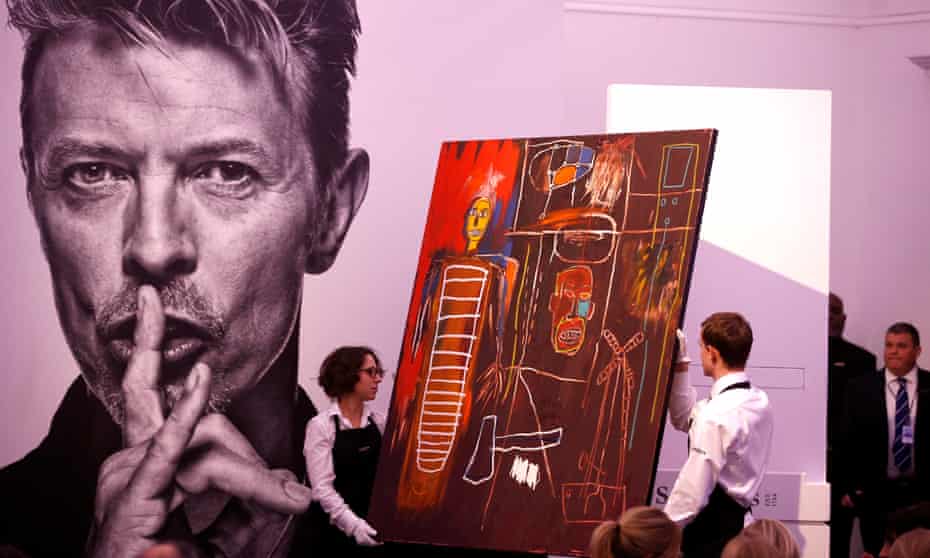 Jean-Michel Basquiat’s Air Power is removed from a plinth by Sotheby’s staff after its sale.