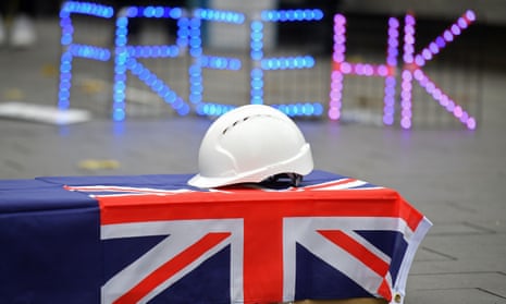 A free Hong Kong protest showing a coffin draped in a union flag with a hard hat on top