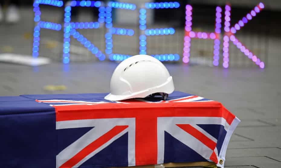 A hard hat is seen on a coffin, as protesters gather at an event organised to mourn the loss of Hong Kong’s political freedoms, in Leicester Square, central London