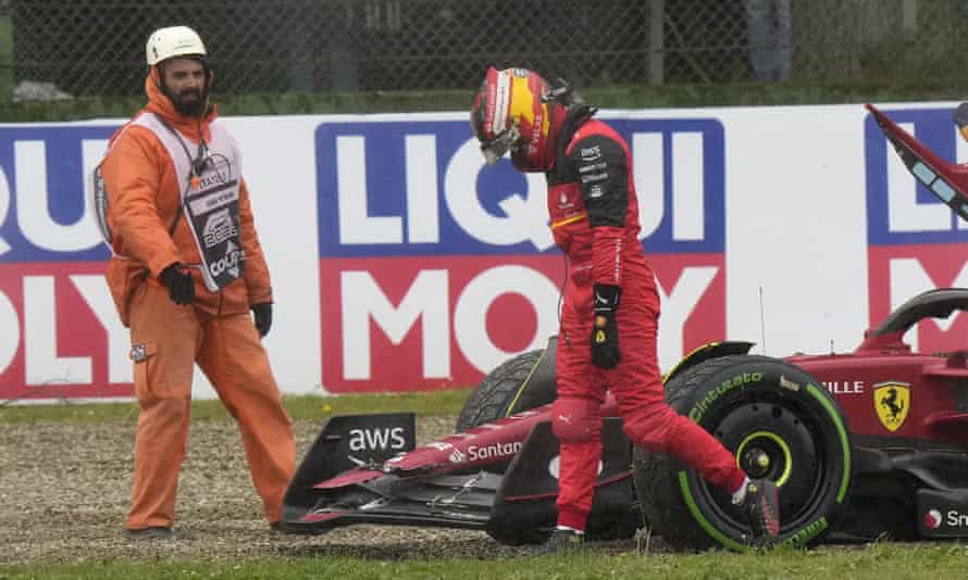 Out: Ferrari driver Carlos Sainz of Spain walks after crashing.